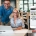 Professionals discussing integrated security systems at a desk with a laptop, emphasizing business security solutions.