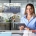 Woman using a tablet in a modern office environment, reflecting the importance of integrated security systems for businesses.